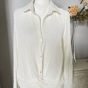NWT This item is a BCX long sleeve blouse twist front at the hem